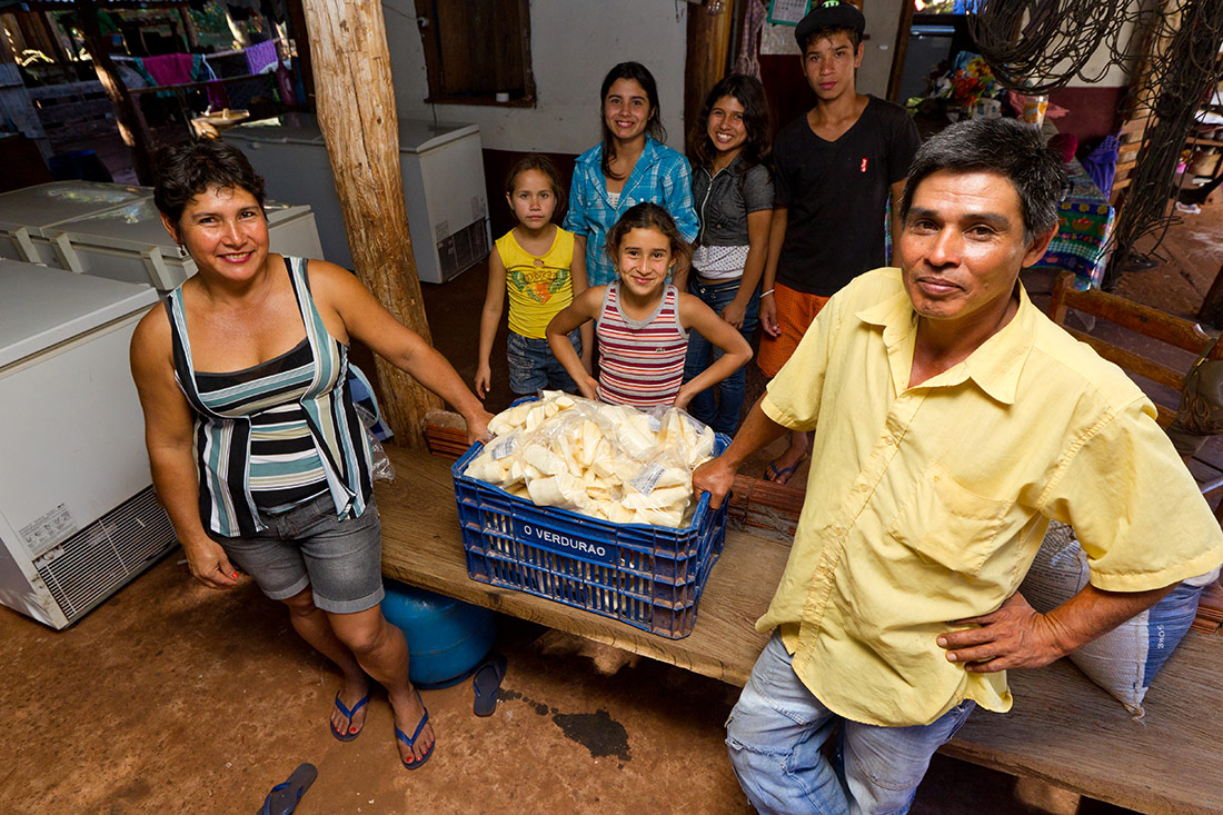 Marli de Almeida , o esposo Graciano Fernandes e os filhos mostram a produção de mandioca que fornecem para o comércio local. (Foto: Ana Nascimento/MDS)